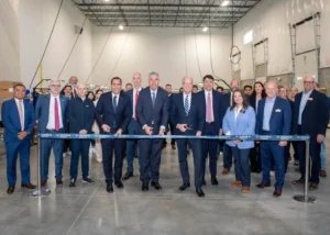 Indra Group CEO José Vicente de los Mozos, center, and U.S. Sen. Jerry Moran, right, help cut the ribbon on new Indra Air Traffic Facility.